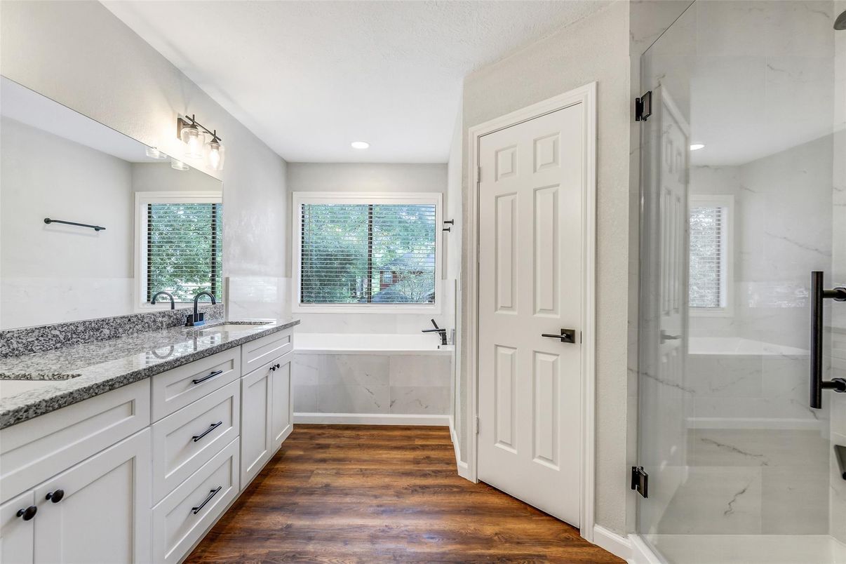 Bathroom, Dual Sink Vanities, Interior, Marble Walls, Recessed Lighting, Wood Texture Flooring