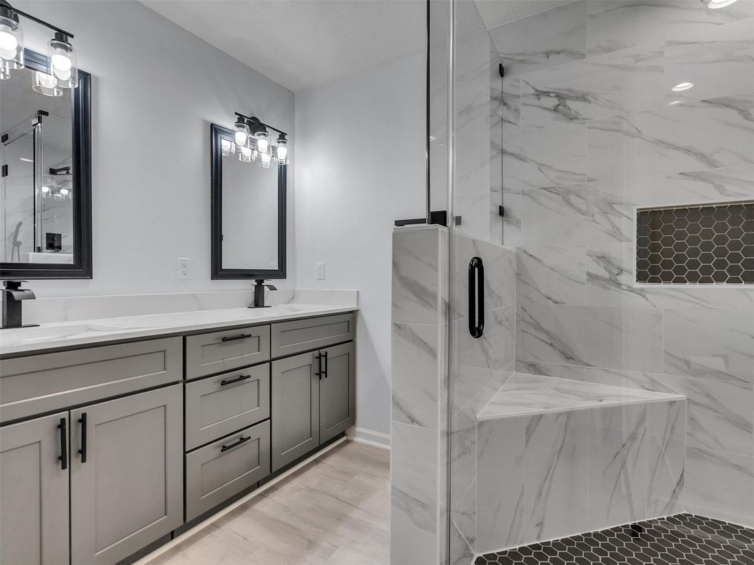 Bathroom, Dual Sink Vanities, Glass Shower, Interior, Marble Walls, Wood Texture Flooring