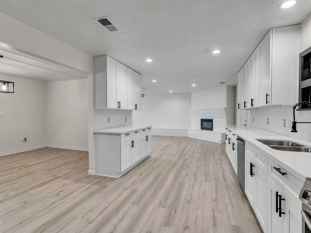 Fireplace, Interior, Kitchen, Recessed Lighting, Stainless Steel Appliances, Stone Walls, Wood Texture Flooring