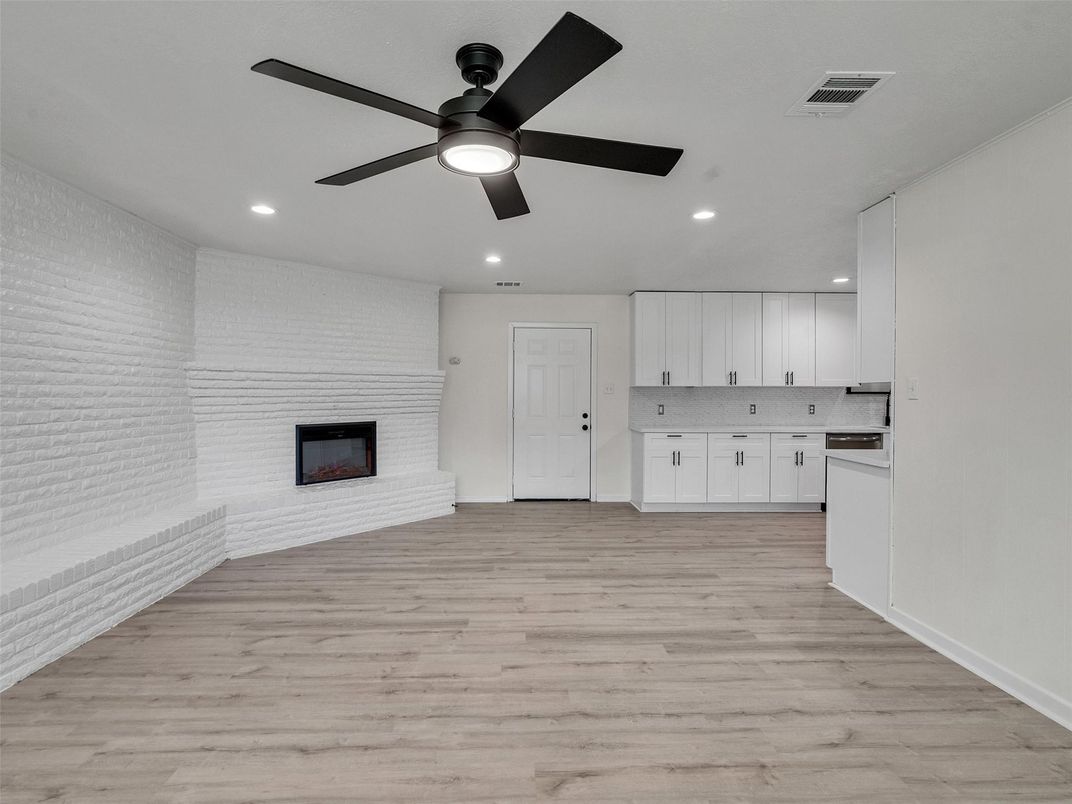 Empty room, Fireplace, Interior, Kitchen, Recessed Lighting, Wood Texture Flooring