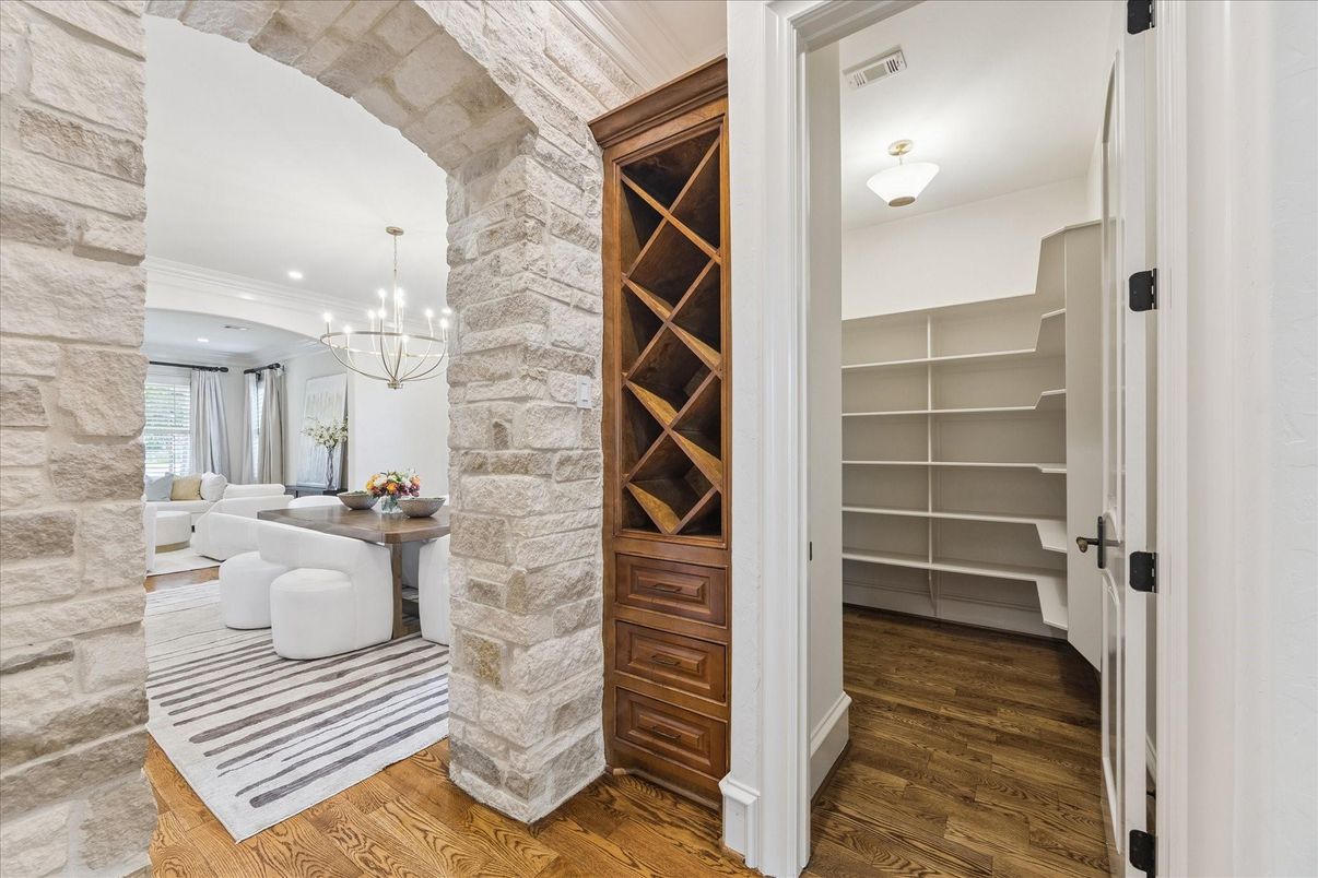 Chandelier, Interior, Recessed Lighting, Stone Walls, Wine Storage, Wood Texture Flooring