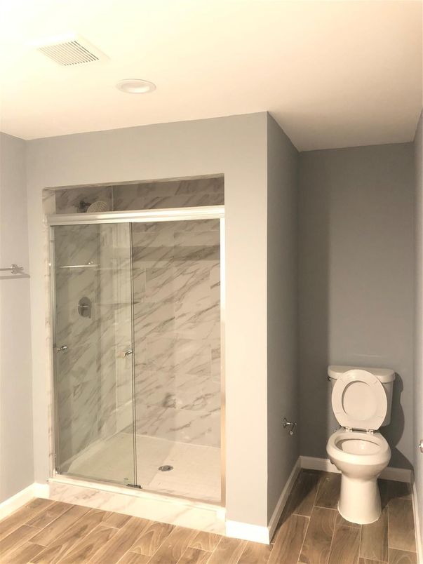 Bathroom, Glass Shower, Interior, Marble Walls, Recessed Lighting, Wood Texture Flooring