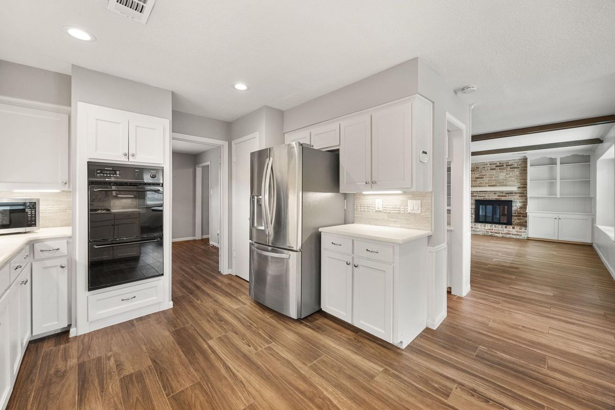 Fireplace, Interior, Kitchen, Recessed Lighting, Stainless Steel Appliances, Wood Texture Flooring