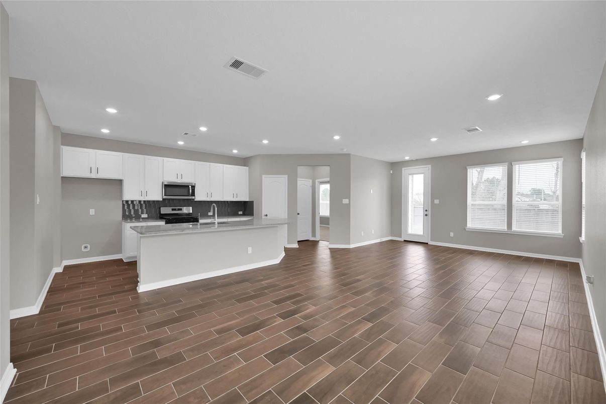Empty room, Interior, Kitchen, Recessed Lighting, Stainless Steel Appliances, Wood Texture Flooring