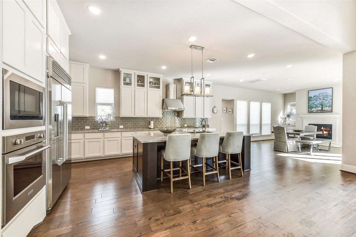 Dining room, Fireplace, Interior, Kitchen, Living room, Pendant Lights, Recessed Lighting, Stainless Steel Appliances, Wood Texture Flooring