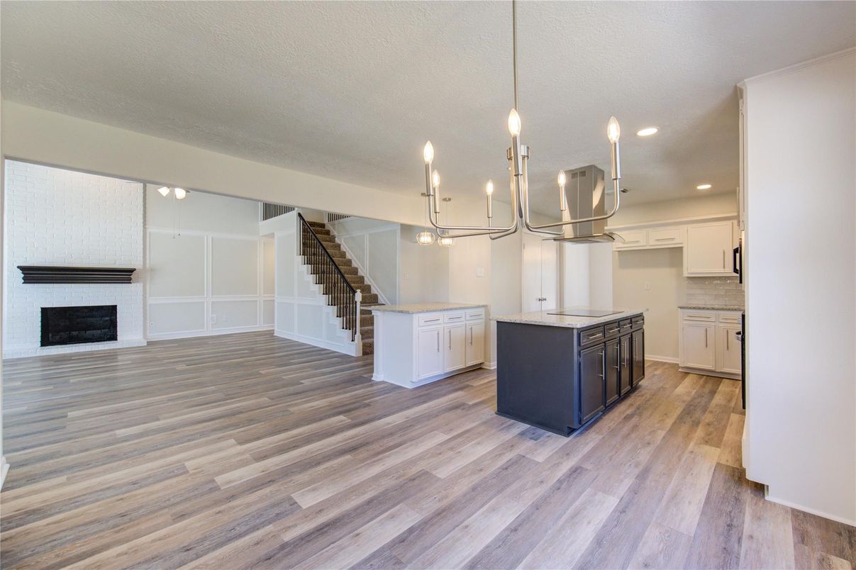 Empty room, Fireplace, Interior, Kitchen, Pendant Lights, Recessed Lighting, Wood Texture Flooring