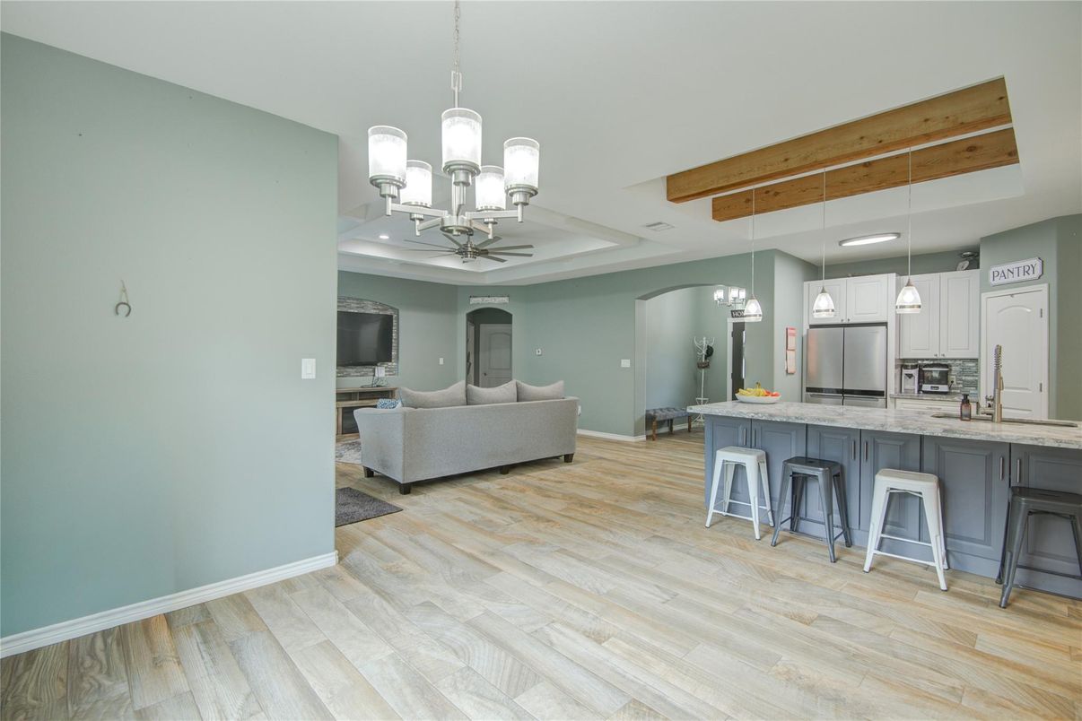 Chandelier, Interior, Kitchen, Living room, Pendant Lights, Recessed Lighting, Stainless Steel Appliances, Wooden Beams, Wood Texture Flooring