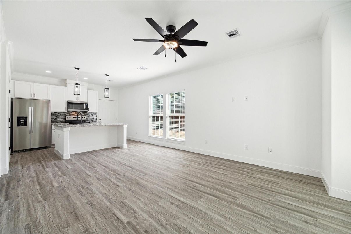 Empty room, Interior, Kitchen, Pendant Lights, Recessed Lighting, Stainless Steel Appliances, Wood Texture Flooring