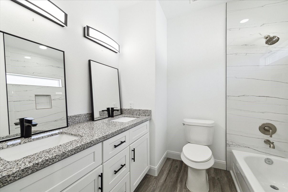 Bathroom, Dual Sink Vanities, Interior, Marble Walls, Recessed Lighting, Wood Texture Flooring