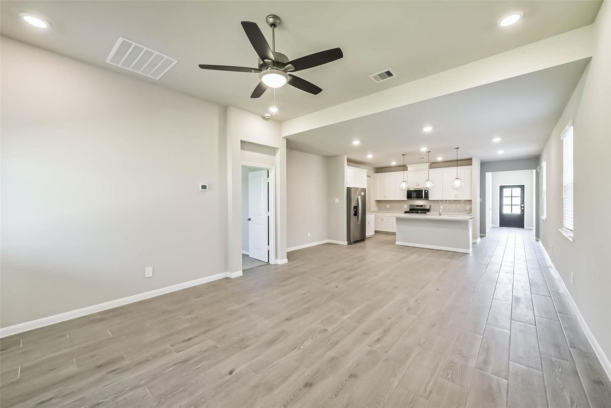Empty room, Interior, Kitchen, Pendant Lights, Recessed Lighting, Stainless Steel Appliances, Wood Texture Flooring