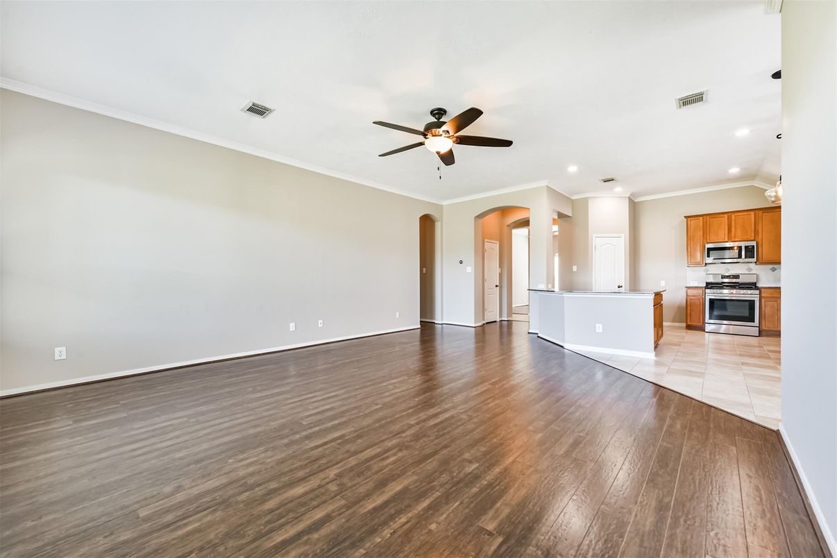 Empty room, Interior, Kitchen, Recessed Lighting, Stainless Steel Appliances, Wood Texture Flooring