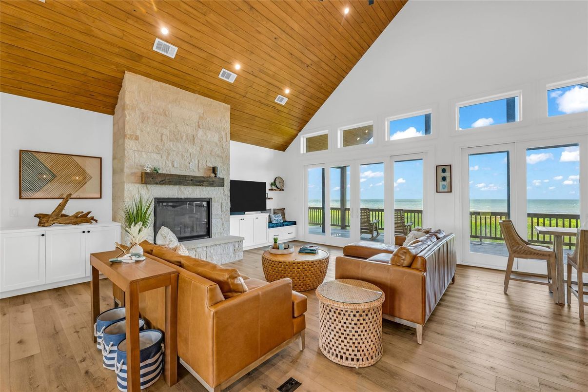 Fireplace, Interior, Living room, Recessed Lighting, Stone Walls, Water, Wooden Ceilings, Wood Texture Flooring