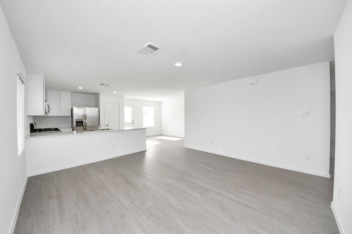 Empty room, Interior, Kitchen, Recessed Lighting, Stainless Steel Appliances, Wood Texture Flooring