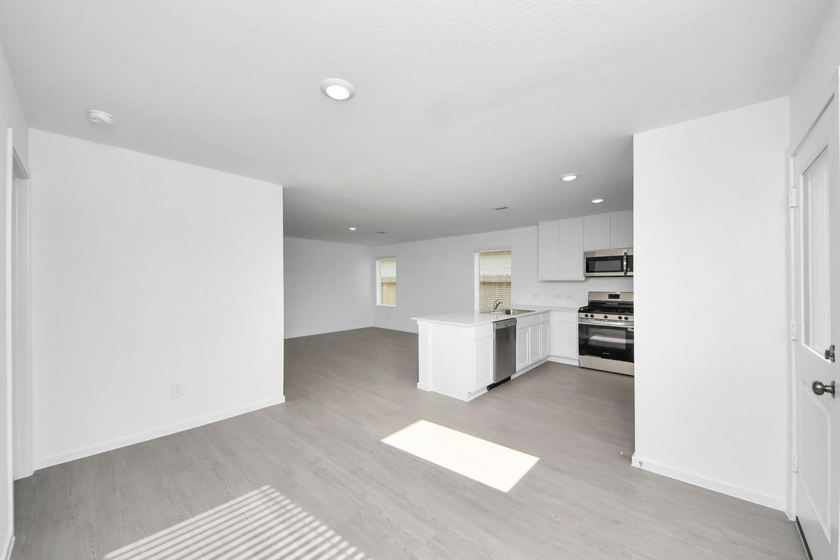 Empty room, Interior, Kitchen, Recessed Lighting, Stainless Steel Appliances, Wood Texture Flooring