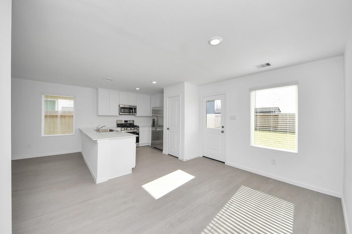 Empty room, Interior, Kitchen, Recessed Lighting, Stainless Steel Appliances, Wood Texture Flooring