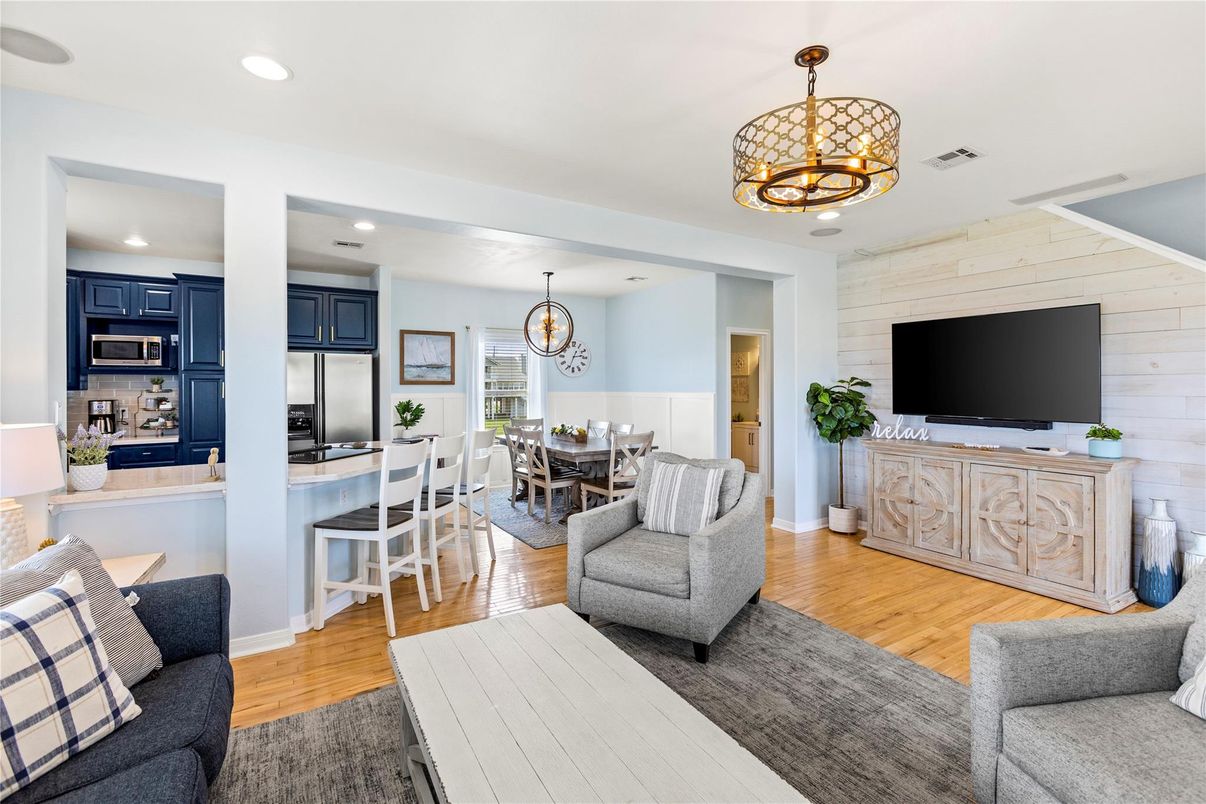 Chandelier, Dining room, Interior, Kitchen, Living room, Pendant Lights, Recessed Lighting, Stainless Steel Appliances, Wood Texture Flooring