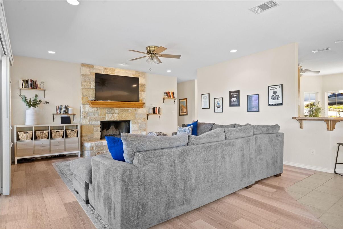 Fireplace, Interior, Living room, Recessed Lighting, Stone Walls, Wood Texture Flooring