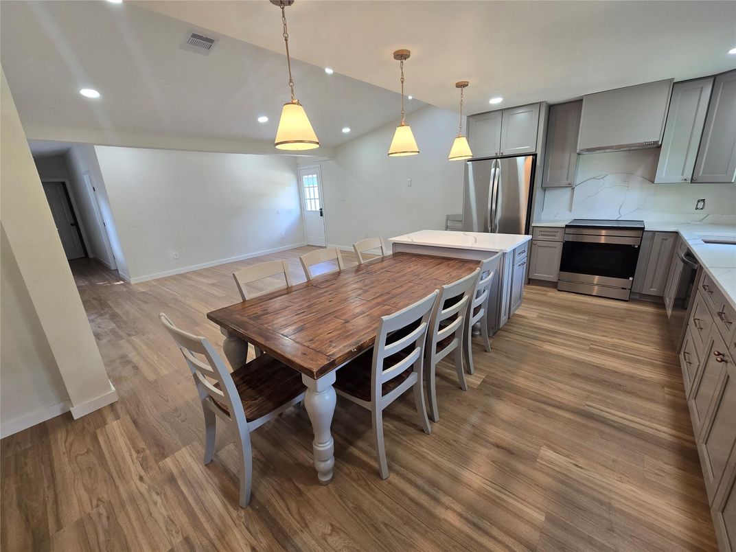 Dining room, Interior, Kitchen, Pendant Lights, Recessed Lighting, Stainless Steel Appliances, Wood Texture Flooring