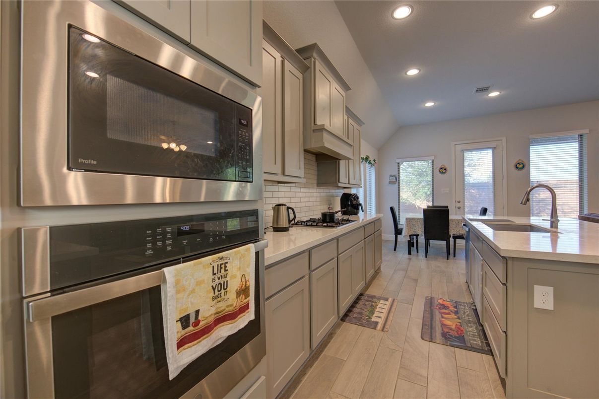 Dining room, Interior, Kitchen, Recessed Lighting, Stainless Steel Appliances, Wood Texture Flooring