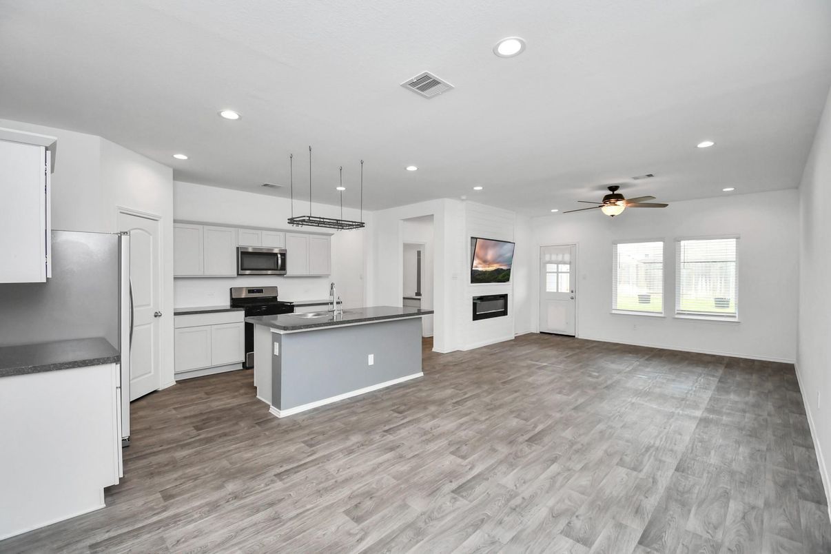 Empty room, Interior, Kitchen, Recessed Lighting, Stainless Steel Appliances, Wood Texture Flooring