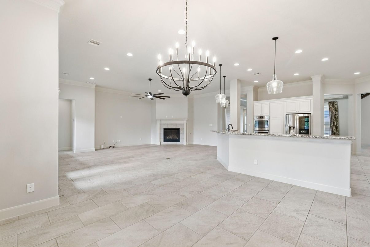 Chandelier, Empty room, Fireplace, Interior, Kitchen, Pendant Lights, Recessed Lighting, Stainless Steel Appliances