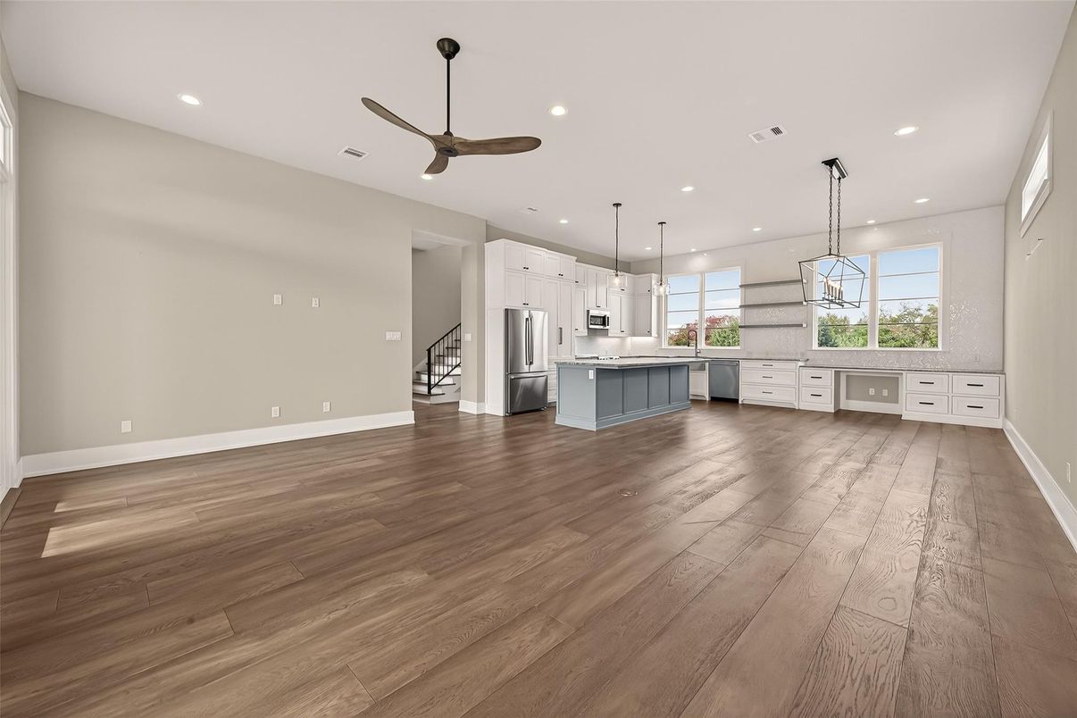 Empty room, Interior, Kitchen, Pendant Lights, Recessed Lighting, Stainless Steel Appliances, Wood Texture Flooring