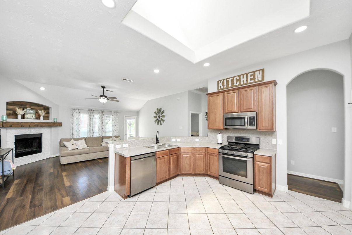 Fireplace, Interior, Kitchen, Living room, Recessed Lighting, Stainless Steel Appliances, Wood Texture Flooring