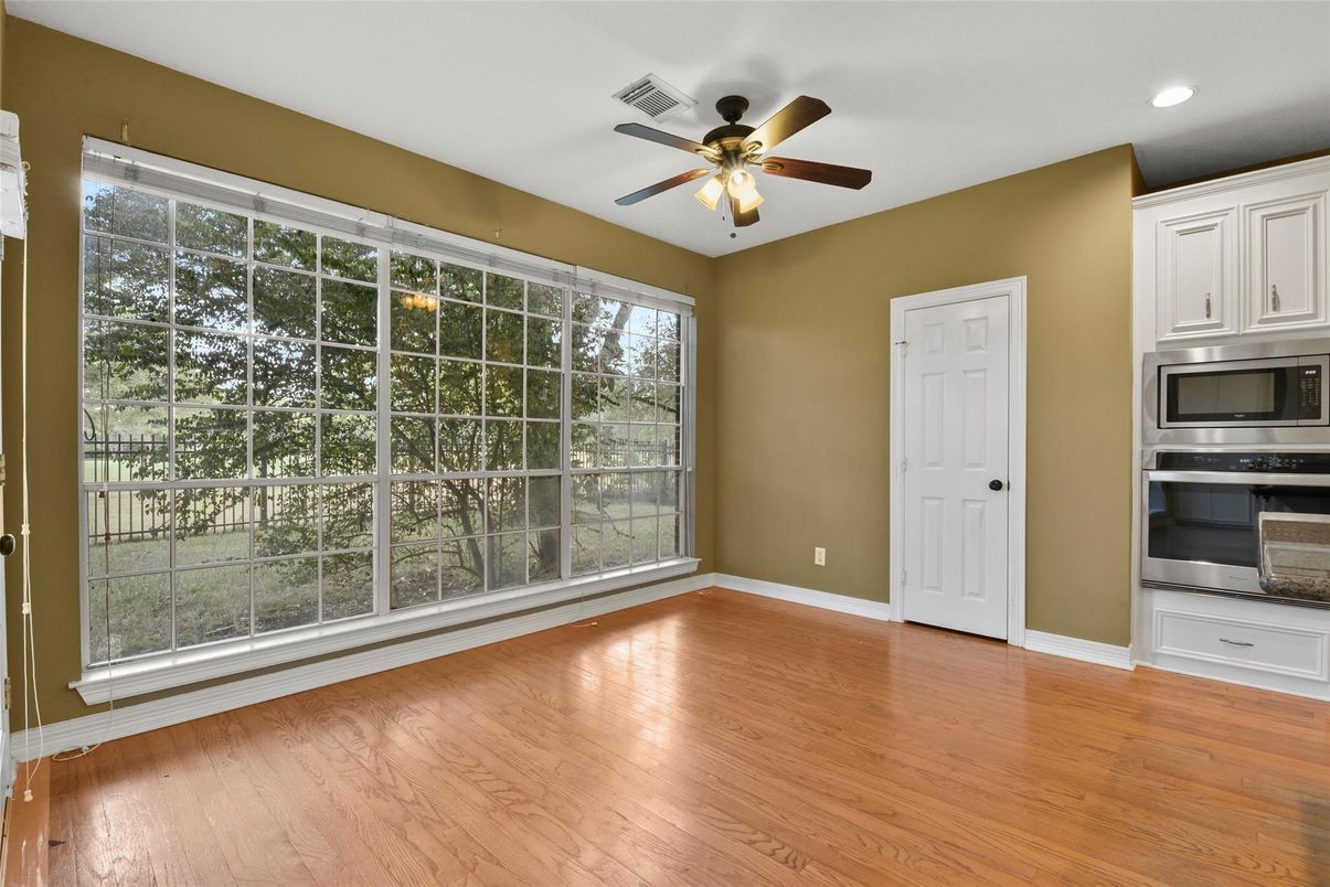 Empty room, Interior, Kitchen, Recessed Lighting, Stainless Steel Appliances, Wood Texture Flooring