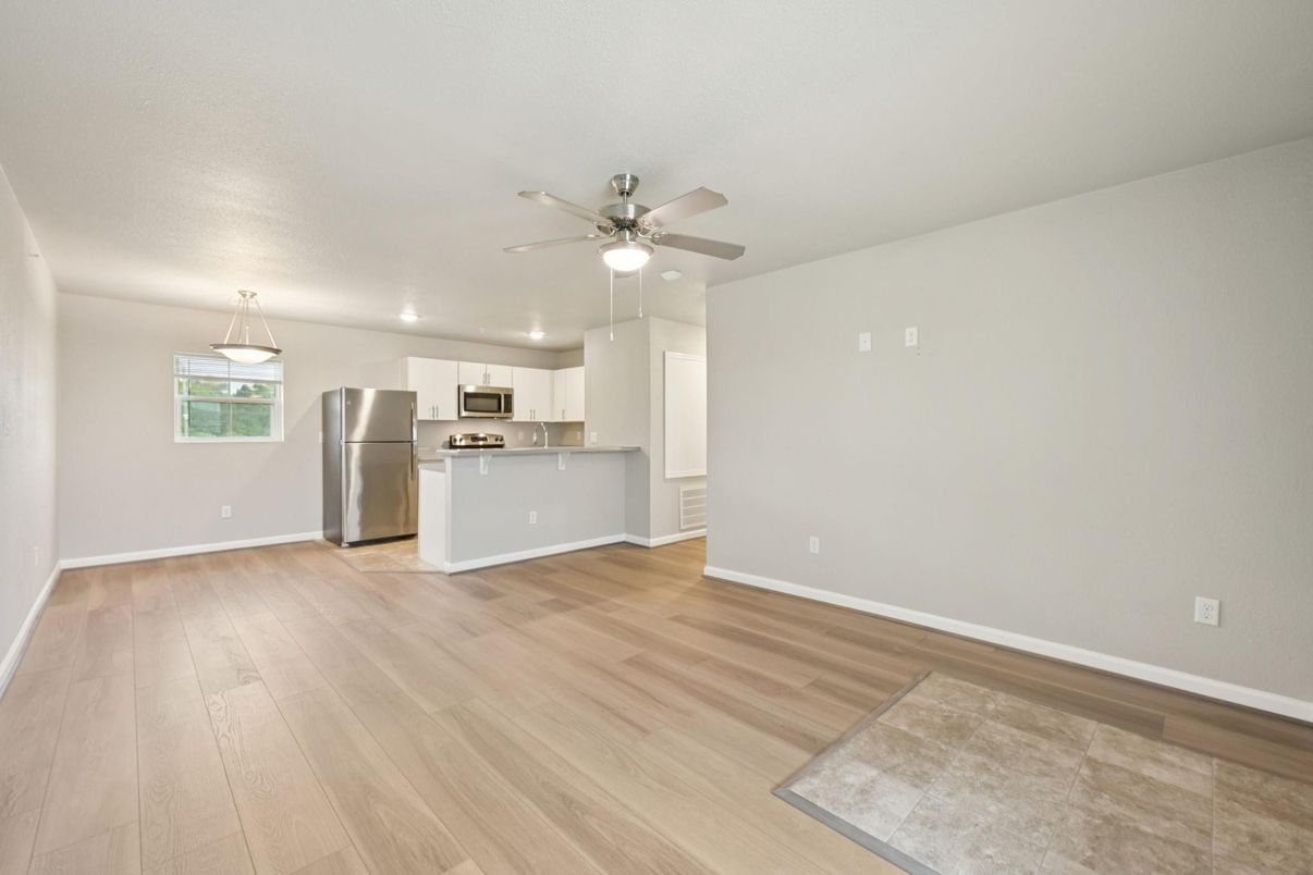 Empty room, Interior, Kitchen, Pendant Lights, Recessed Lighting, Stainless Steel Appliances, Wood Texture Flooring