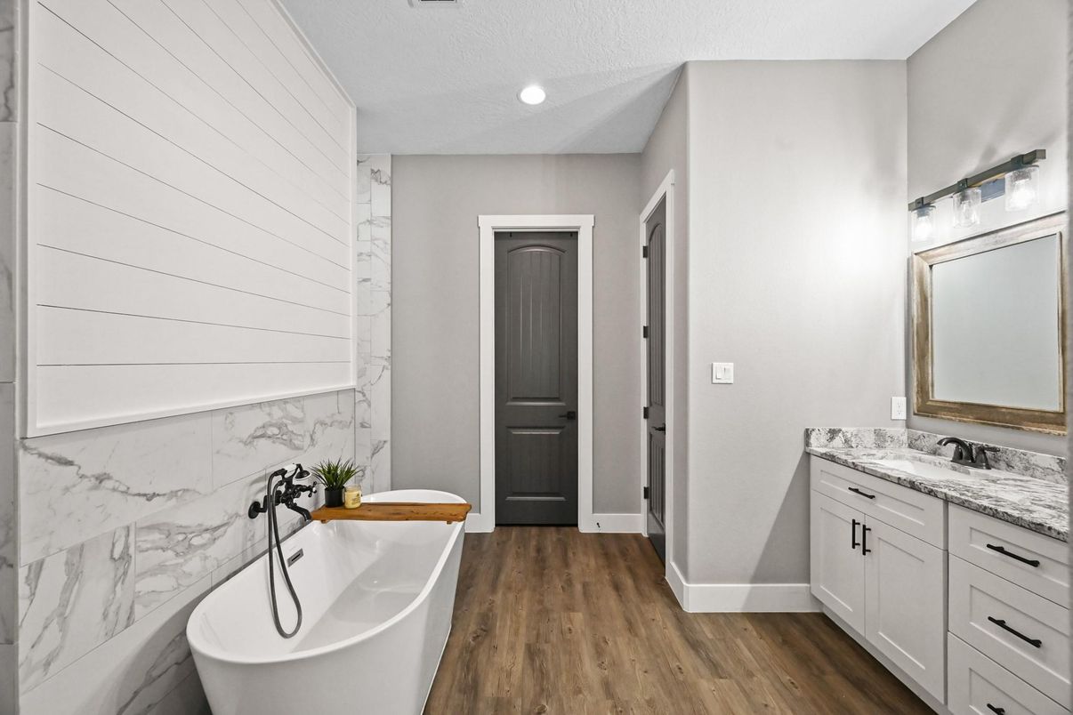 Bathroom, Dual Sink Vanities, Free Standing Baths, Interior, Marble Walls, Recessed Lighting, Wood Texture Flooring
