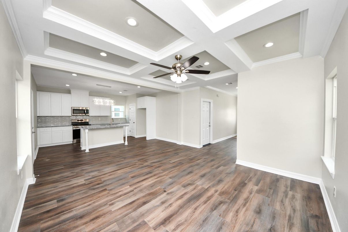 Empty room, Interior, Kitchen, Recessed Lighting, Stainless Steel Appliances, Wood Texture Flooring
