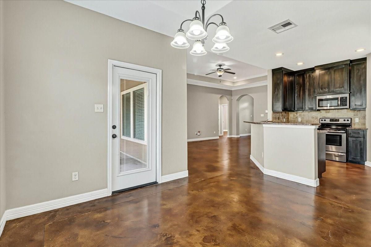 Chandelier, Empty room, Interior, Kitchen, Recessed Lighting, Stainless Steel Appliances, Wood Texture Flooring