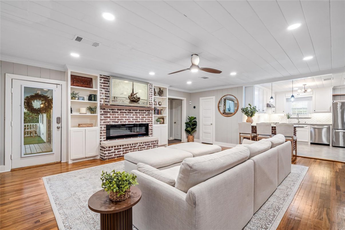 Fireplace, Interior, Kitchen, Living room, Pendant Lights, Recessed Lighting, Stainless Steel Appliances, Stone Walls, Wood Texture Flooring