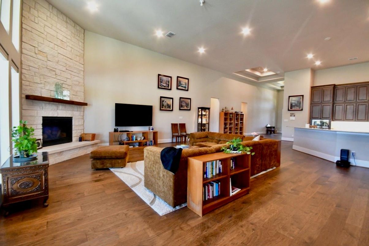 Fireplace, Interior, Living room, Recessed Lighting, Stone Walls, Wood Texture Flooring