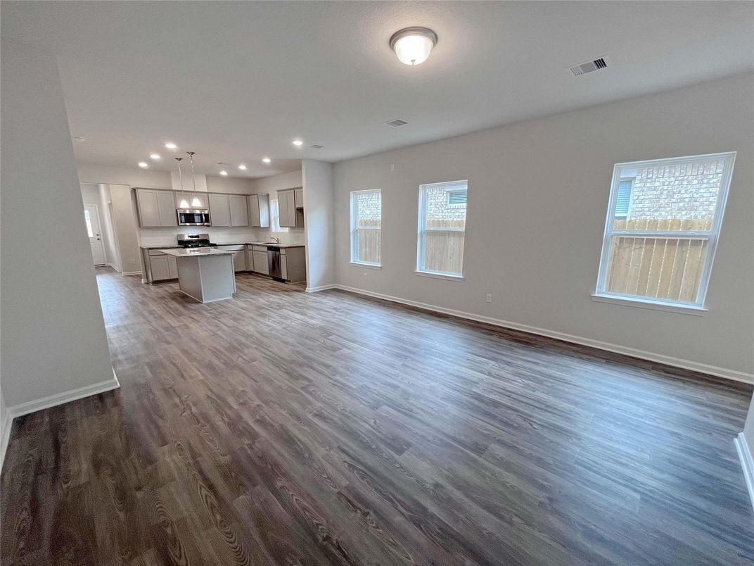 Empty room, Interior, Kitchen, Pendant Lights, Recessed Lighting, Stainless Steel Appliances, Wood Texture Flooring