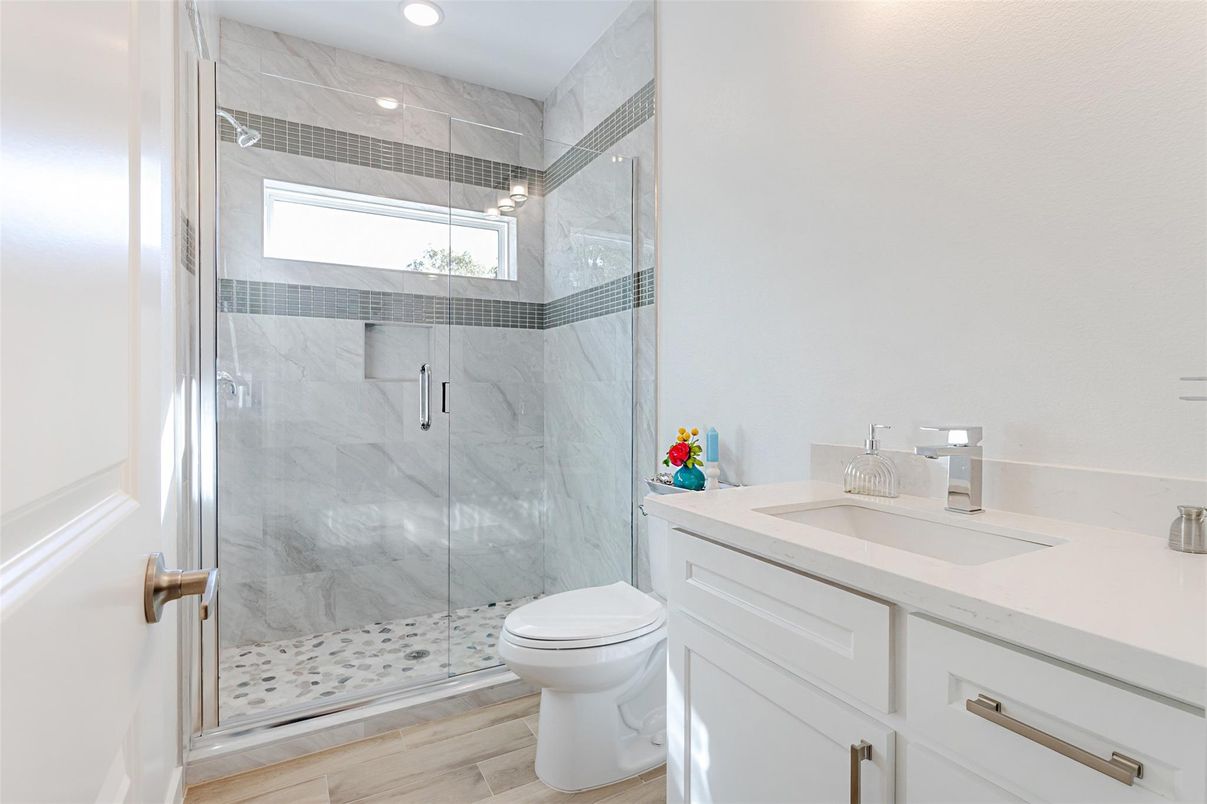 Bathroom, Glass Shower, Interior, Marble Walls, Recessed Lighting, Wood Texture Flooring