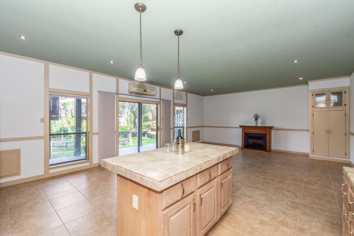 Fireplace, Interior, Kitchen, Pendant Lights, Recessed Lighting, Tile Countertops