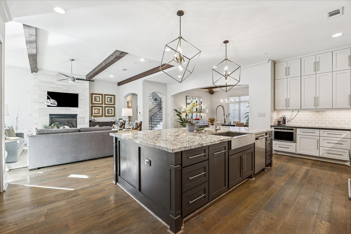 Fireplace, Interior, Kitchen, Living room, Pendant Lights, Recessed Lighting, Stainless Steel Appliances, Stone Walls, Wooden Beams, Wood Texture Flooring