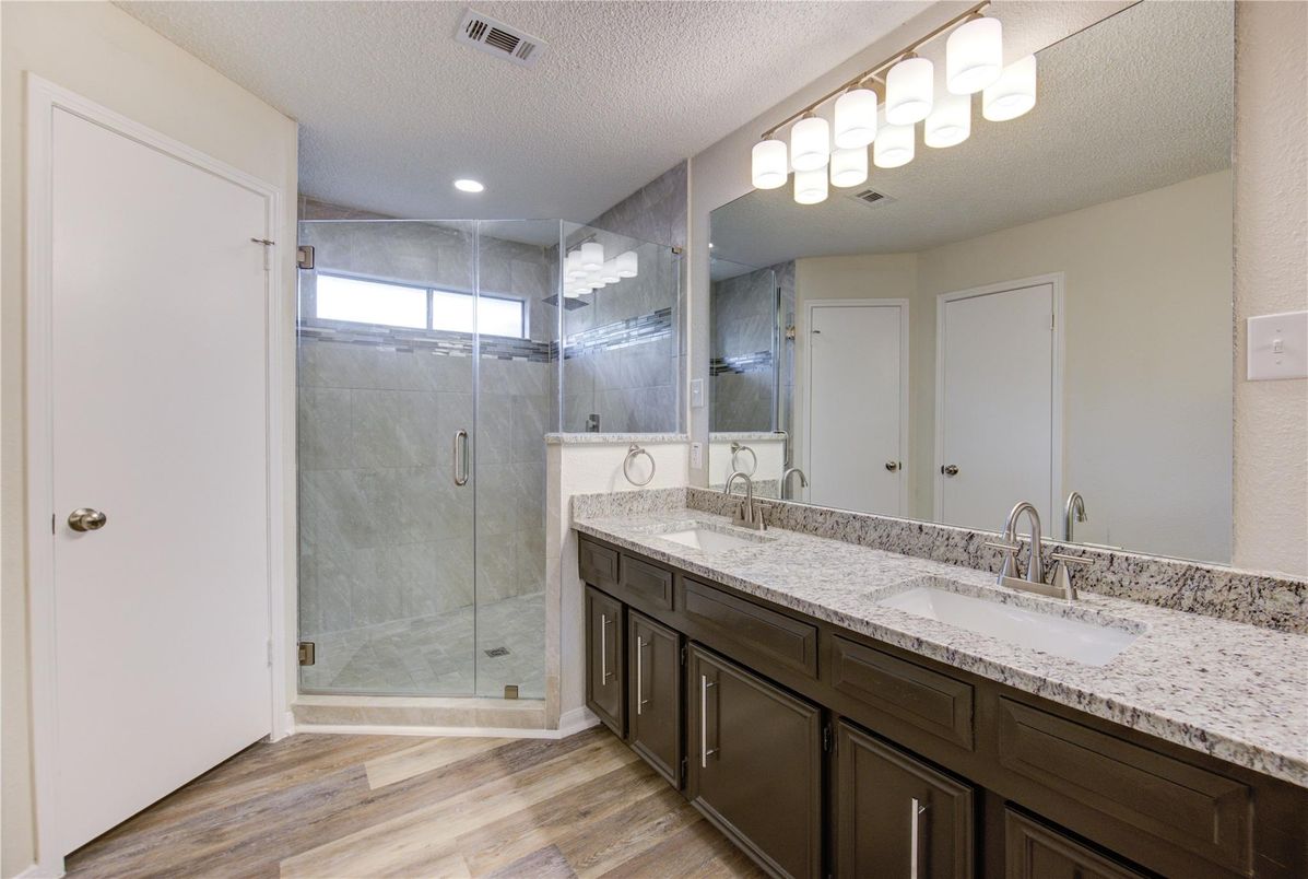 Bathroom, Dual Sink Vanities, Glass Shower, Interior, Recessed Lighting, Wood Texture Flooring