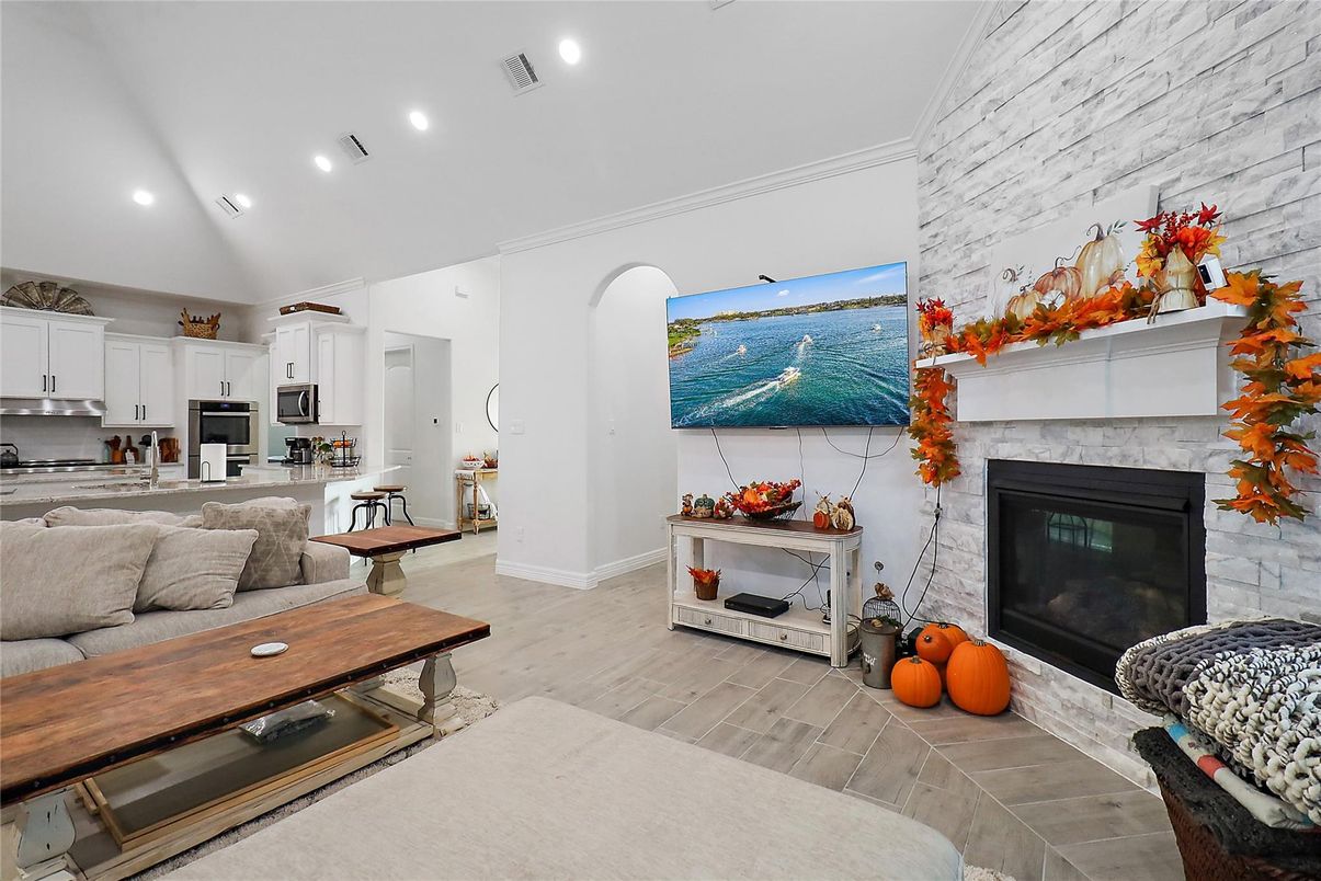 Fireplace, Interior, Kitchen, Living room, Recessed Lighting, Stainless Steel Appliances, Stone Walls, Wood Texture Flooring