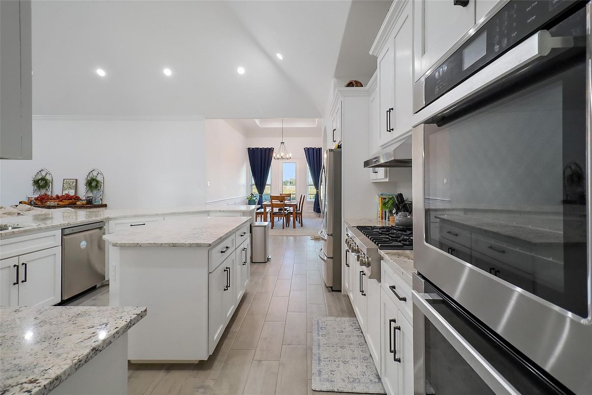 Chandelier, Dining room, Interior, Kitchen, Pendant Lights, Recessed Lighting, Stainless Steel Appliances, Wood Texture Flooring