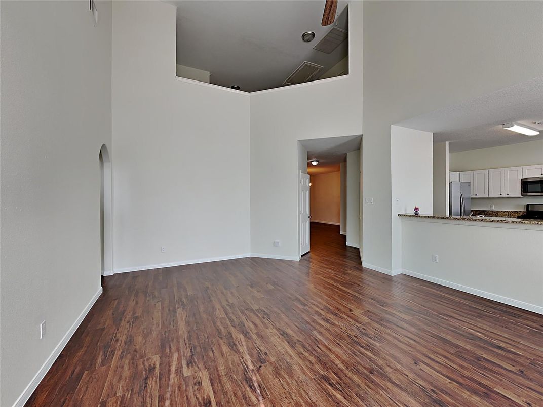 Empty room, Interior, Kitchen, Recessed Lighting, Stainless Steel Appliances, Wood Texture Flooring