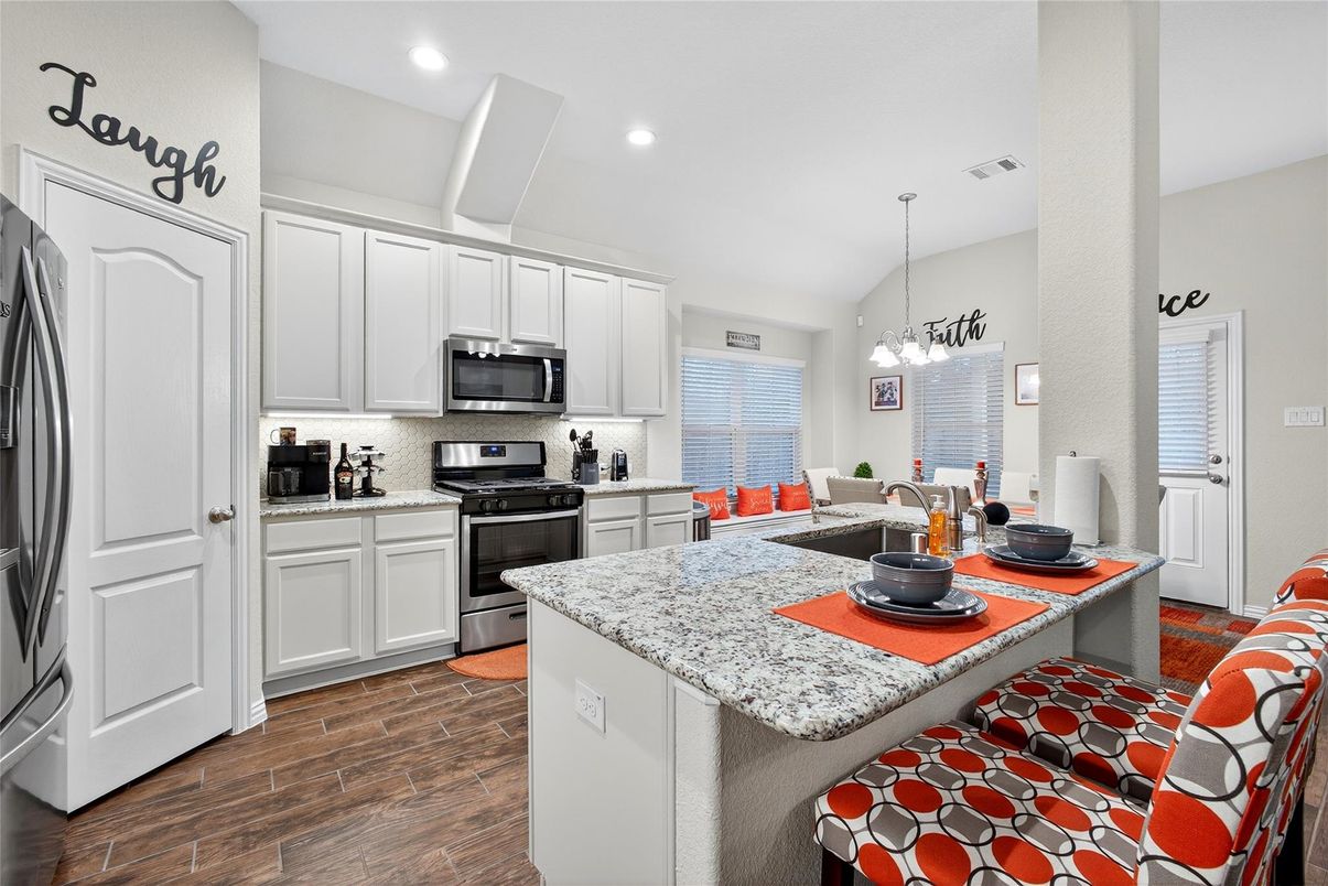 Dining room, Interior, Kitchen, Pendant Lights, Recessed Lighting, Stainless Steel Appliances, Wood Texture Flooring