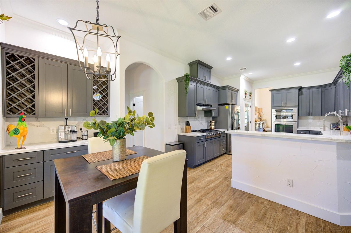 Dining room, Interior, Kitchen, Pendant Lights, Recessed Lighting, Stainless Steel Appliances, Wood Texture Flooring