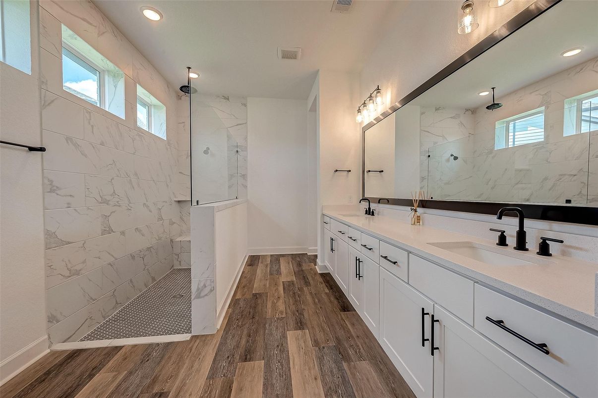 Bathroom, Dual Sink Vanities, Glass Shower, Interior, Marble Walls, Recessed Lighting, Wood Texture Flooring