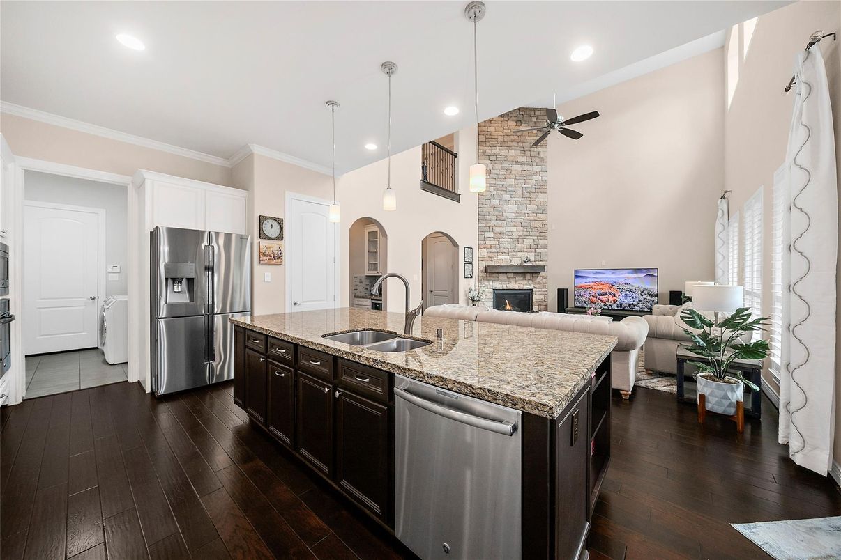 Fireplace, Interior, Kitchen, Living room, Pendant Lights, Recessed Lighting, Stainless Steel Appliances, Stone Walls, Wood Texture Flooring