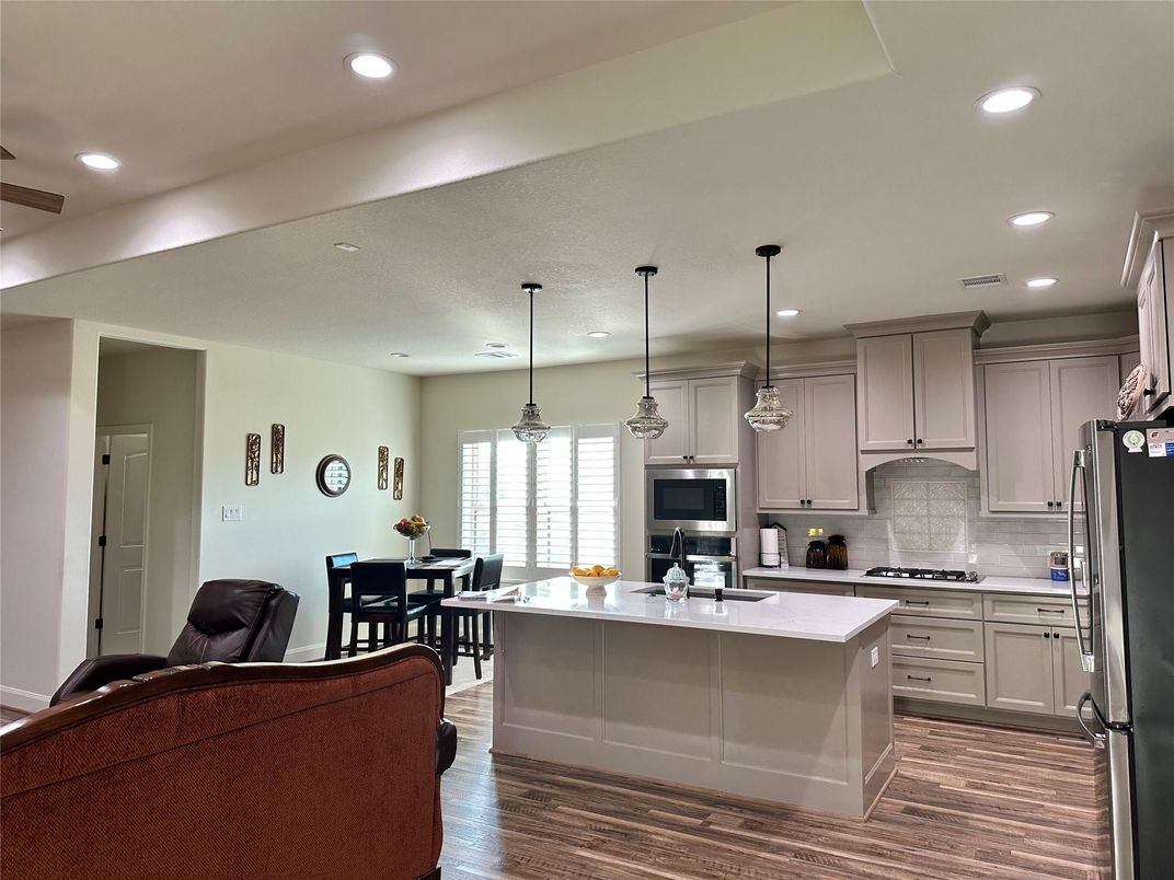Dining room, Interior, Kitchen, Pendant Lights, Recessed Lighting, Stainless Steel Appliances, Wood Texture Flooring
