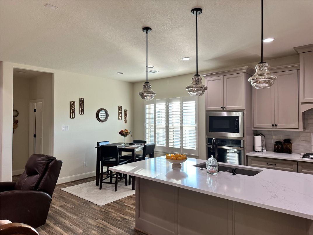 Dining room, Interior, Kitchen, Pendant Lights, Recessed Lighting, Stainless Steel Appliances, Wood Texture Flooring