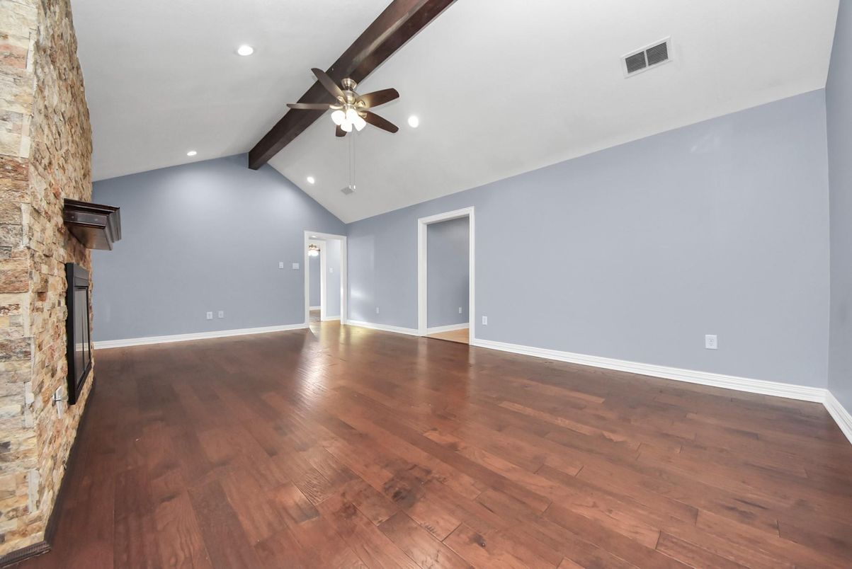 Empty room, Fireplace, Interior, Recessed Lighting, Stone Walls, Wood Texture Flooring