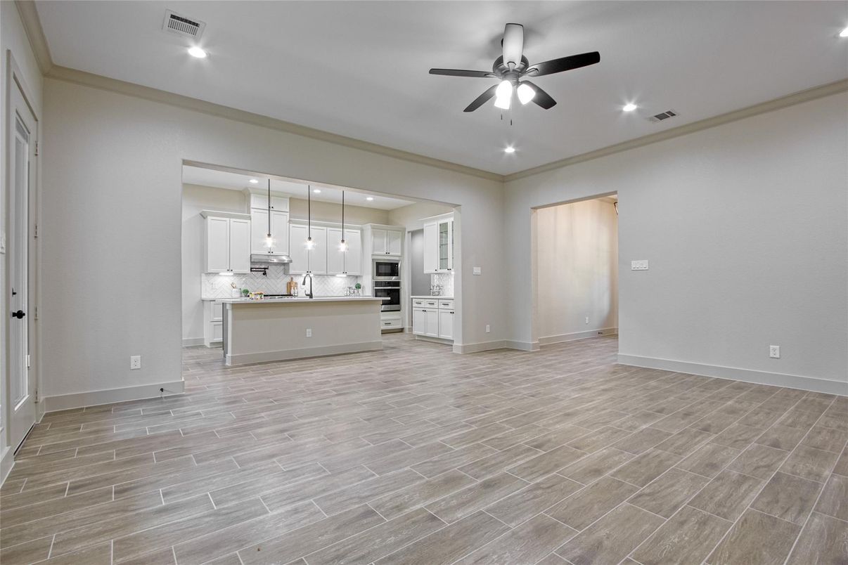 Empty room, Interior, Kitchen, Pendant Lights, Recessed Lighting, Stainless Steel Appliances, Wood Texture Flooring